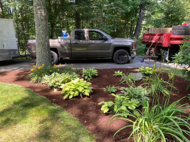 mulch project with gray work truck