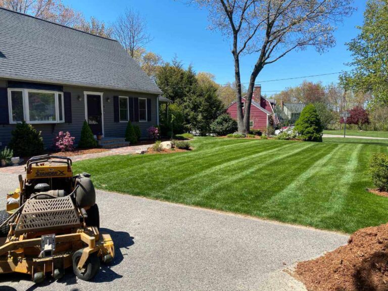 gray home with freshly cut lawn and mulch